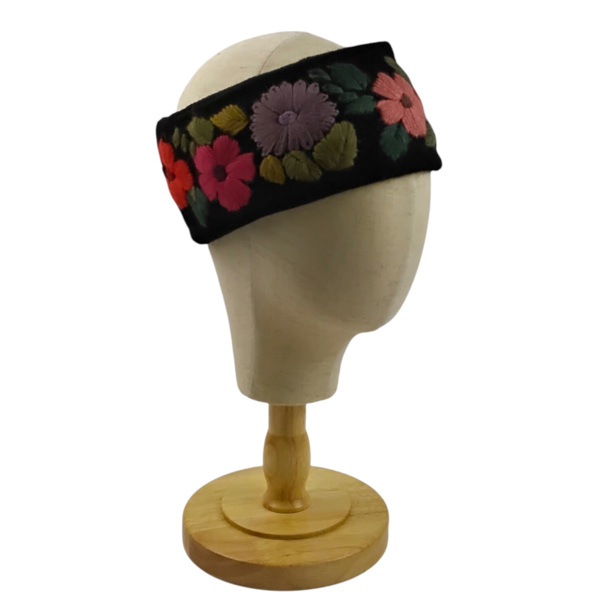 black floral headband on a mannequin head with a white background