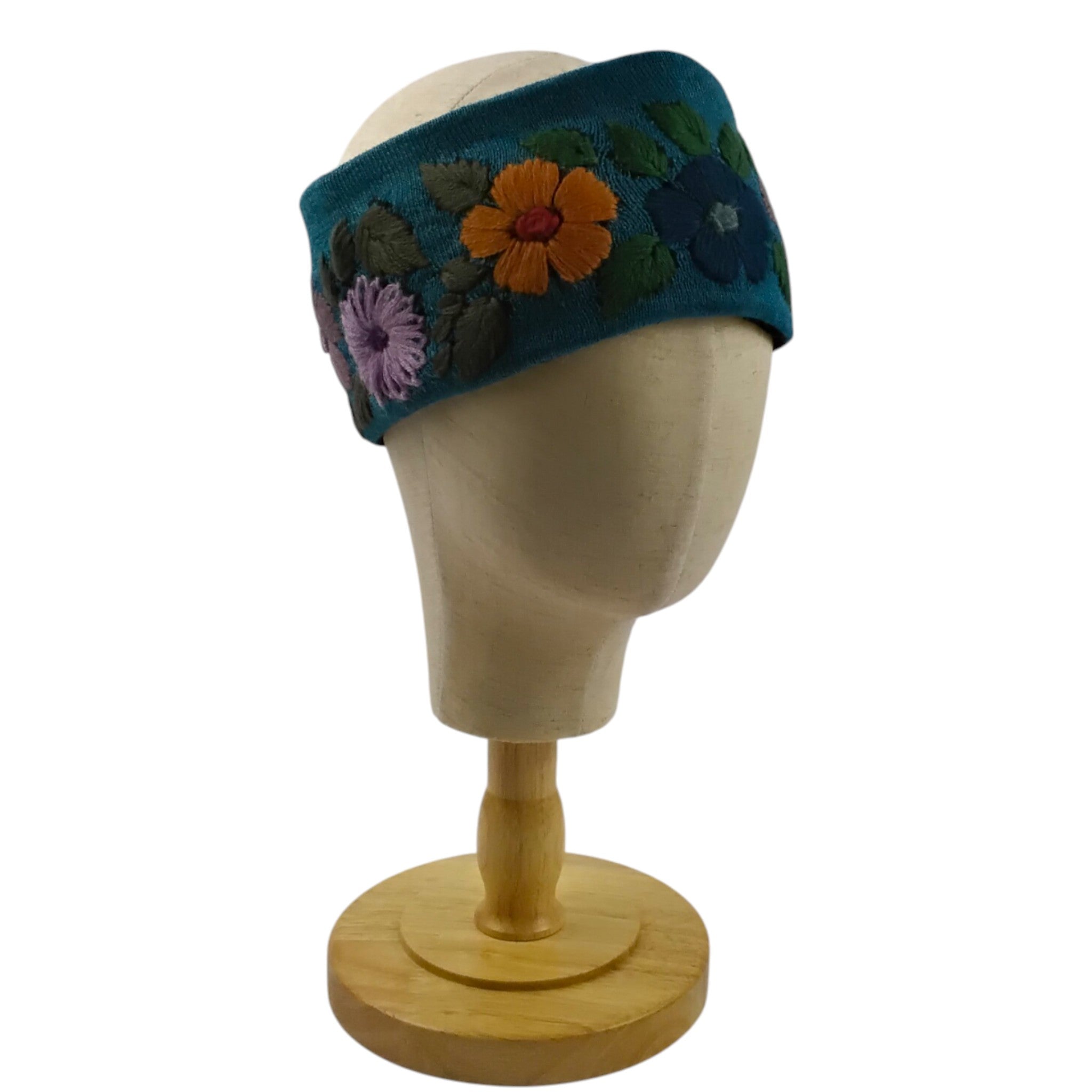 Floral embroidered headband on a mannequin head against a white background