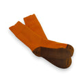 Pair of orange socks with brown soles on a white background