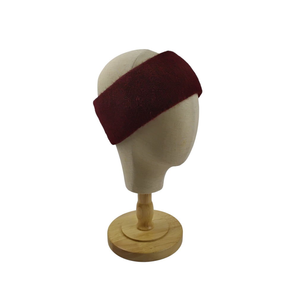 Maroon headband on a mannequin head with a white background