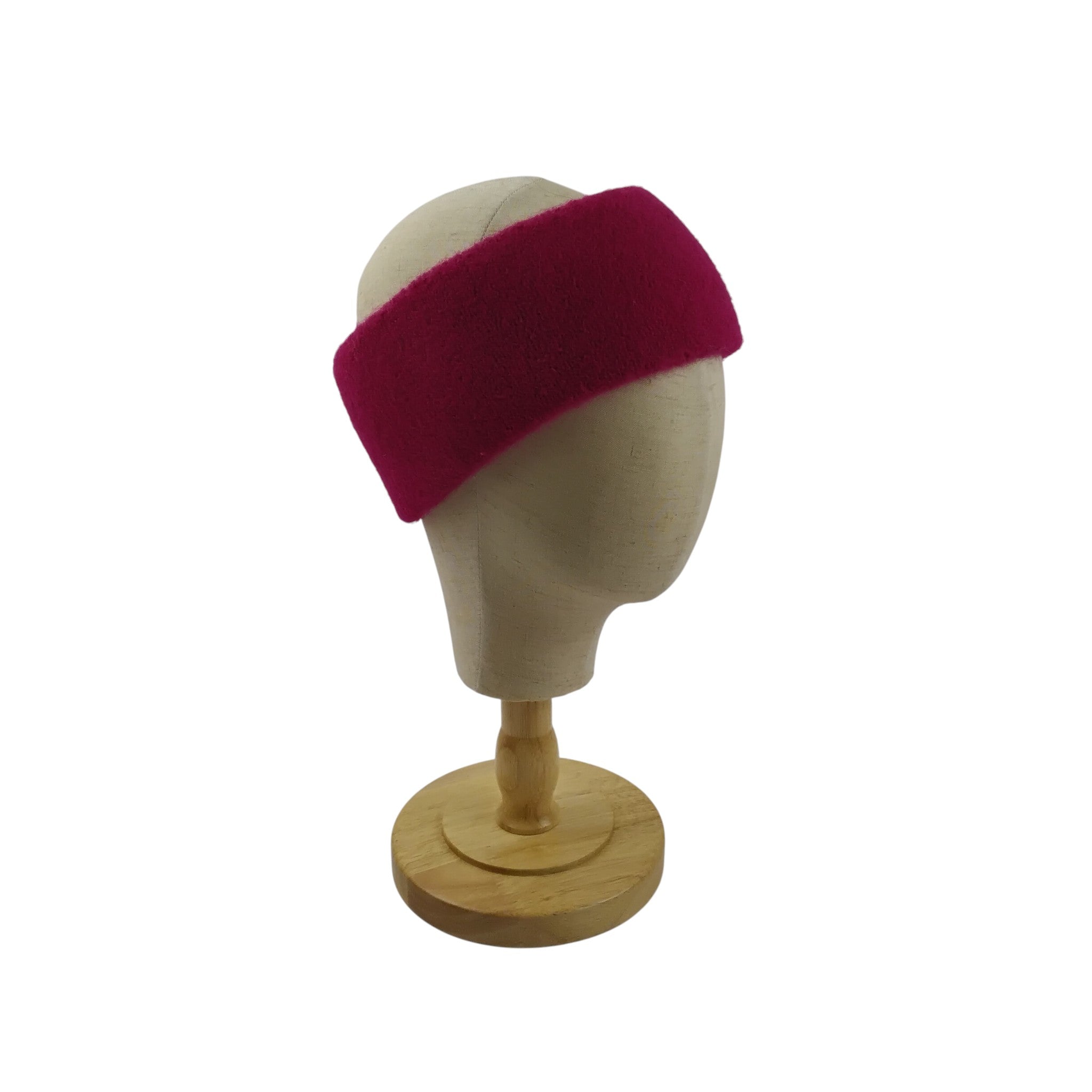 Mannequin head wearing a bright pink headband on a white background